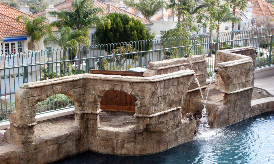 Poolside rock bridge with arched openings