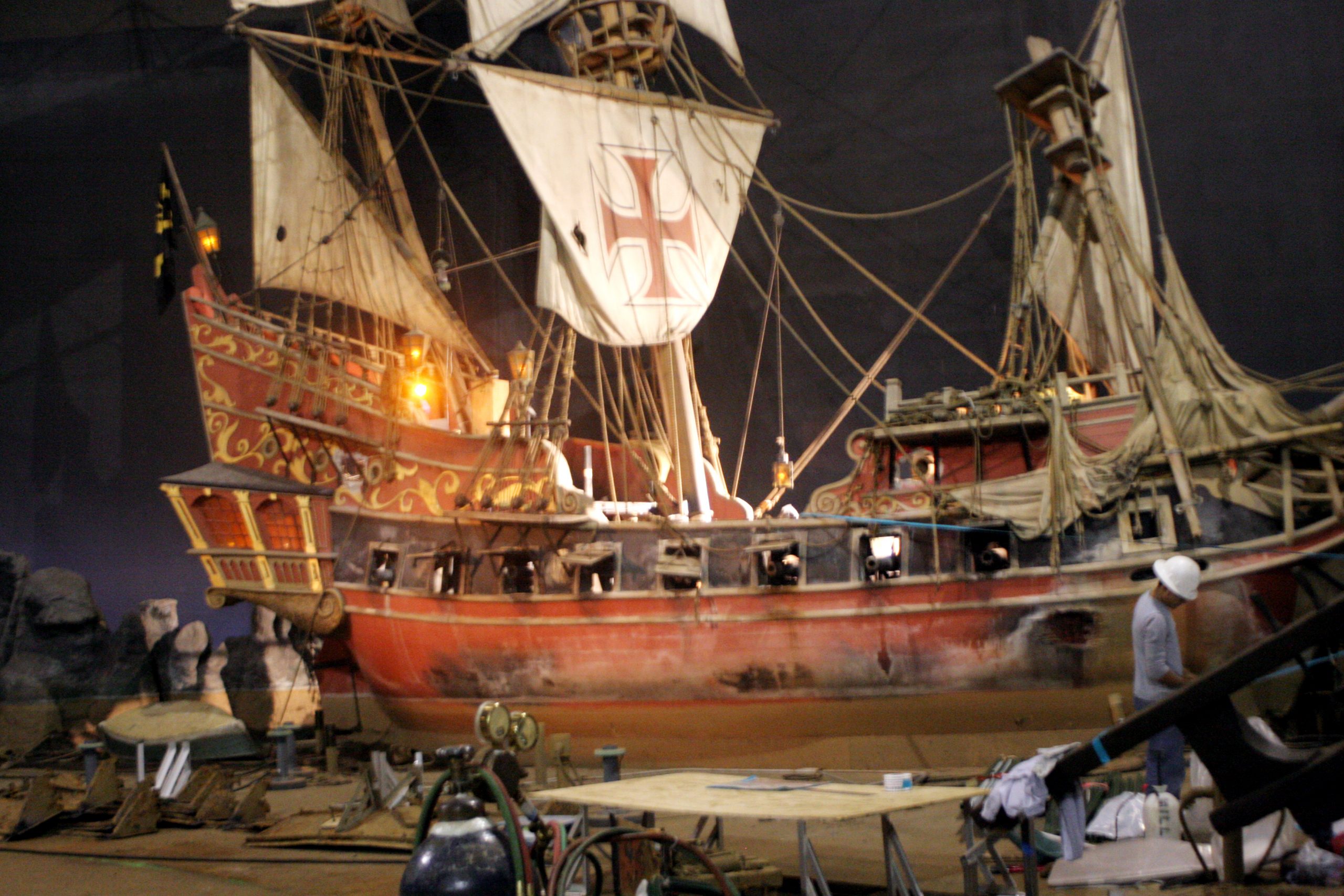 Full-scale replica sailing ship with red cross sails