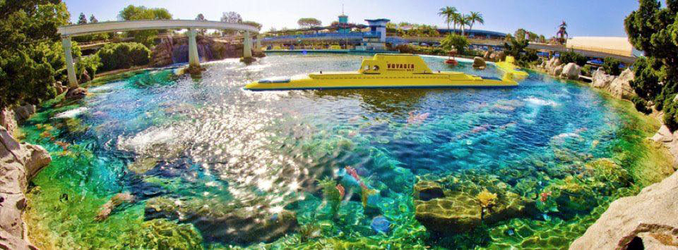 Submarine ride vehicle in teal water at theme park attraction