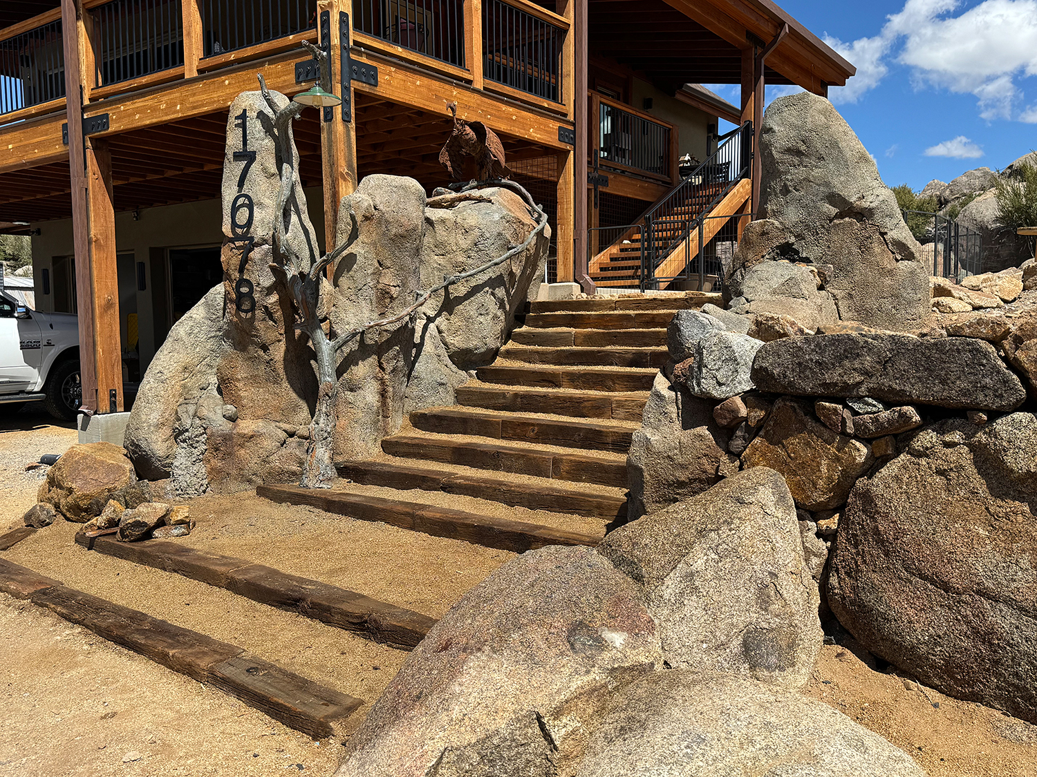 Concrete rock staircase leading to wooden cabin entrance