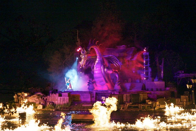 Nighttime theme park spectacular with dragon character